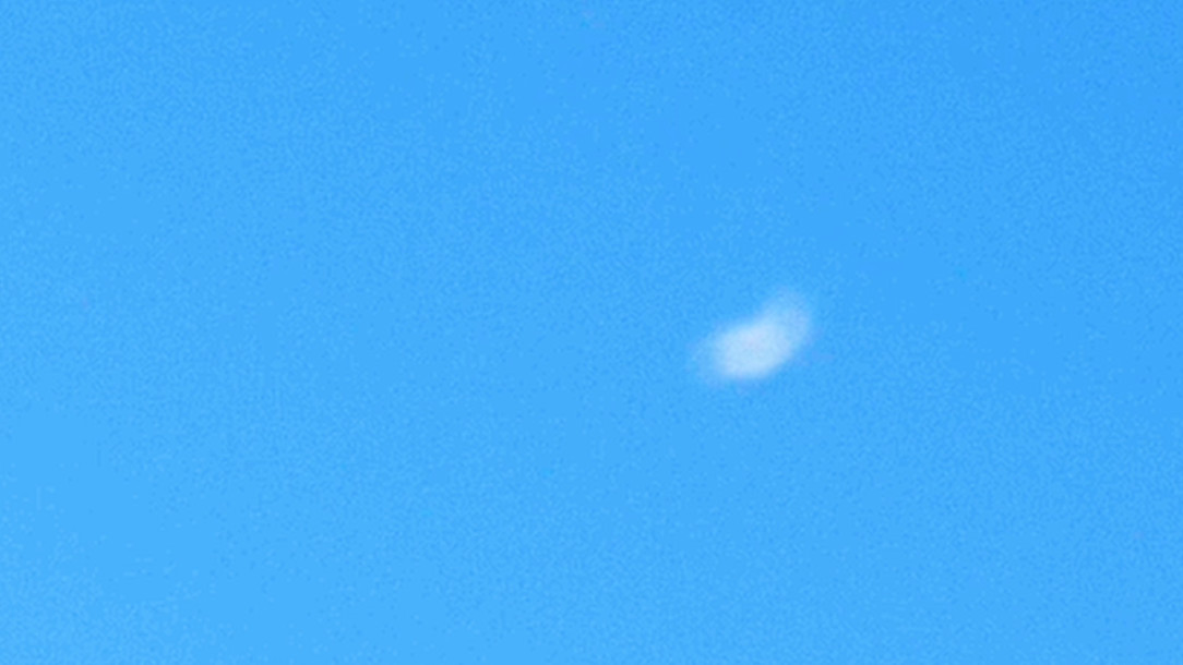 Still: a single small white cloud in an evenly blue sky.