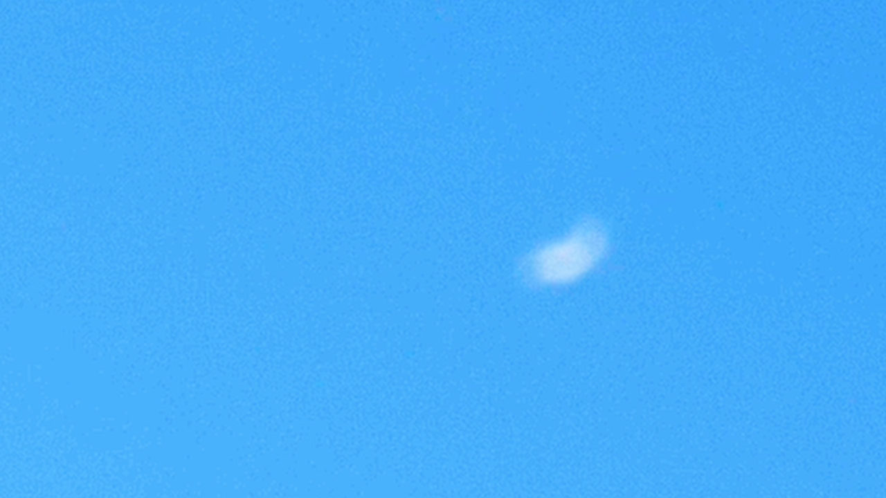 Still: a single small white cloud in an evenly blue sky.
