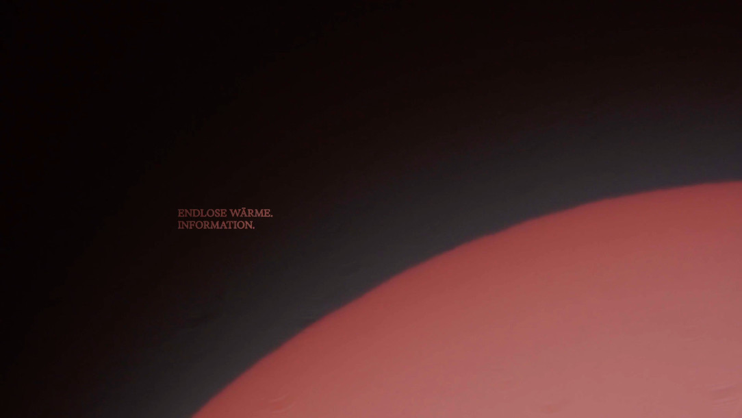 Still: the red-glowing limb of a planet along the lower edge of the frame, two small lines of text above it in the dark.